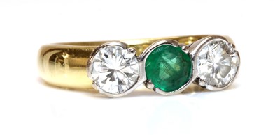 Lot 352 - An 18ct gold emerald and diamond three stone ring