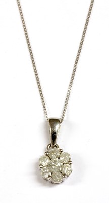 Lot 72 - A white gold diamond daisy cluster pendant