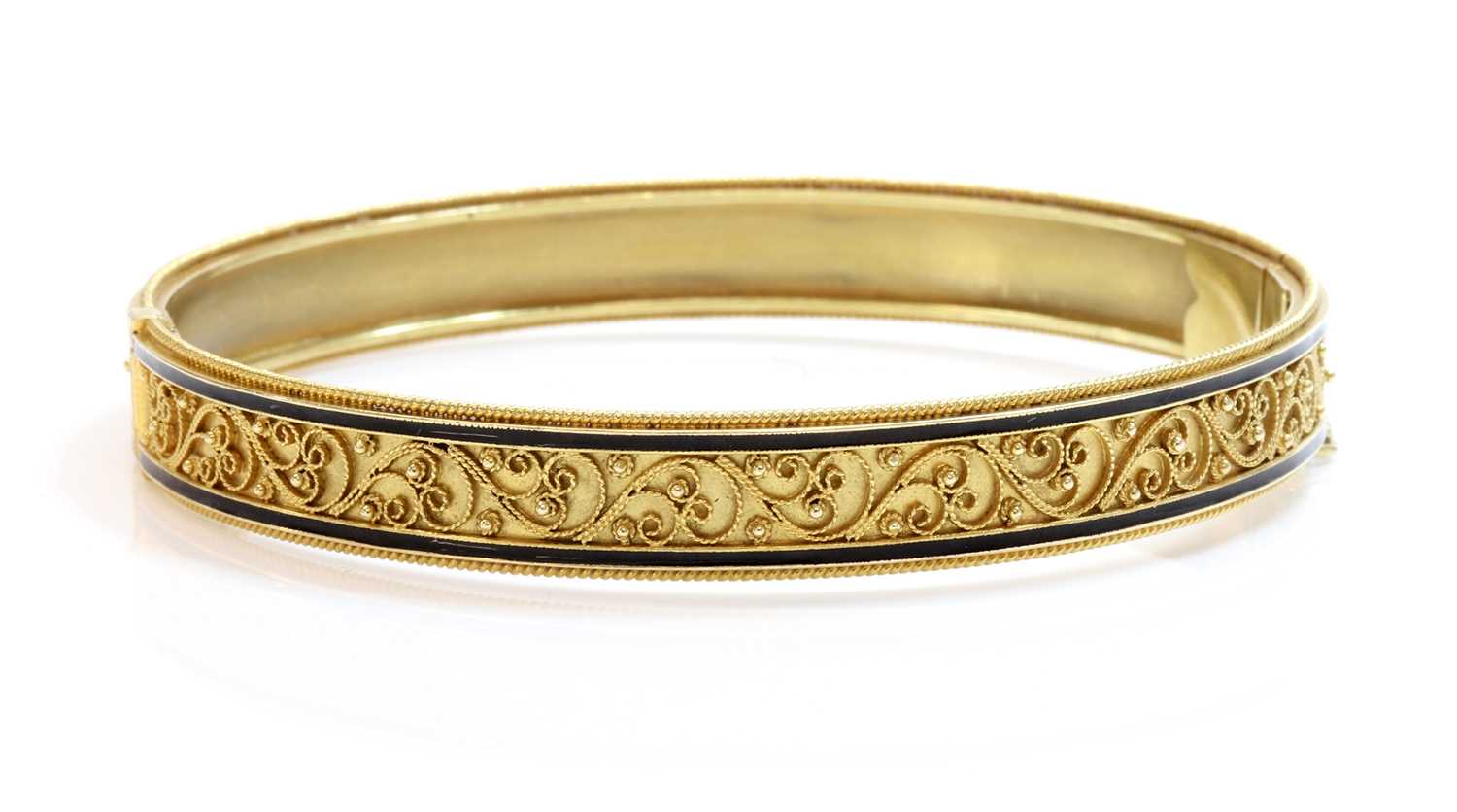 Lot 82 - A Victorian archaeological revival Etruscan style gold and enamel hinged bangle, c.1870