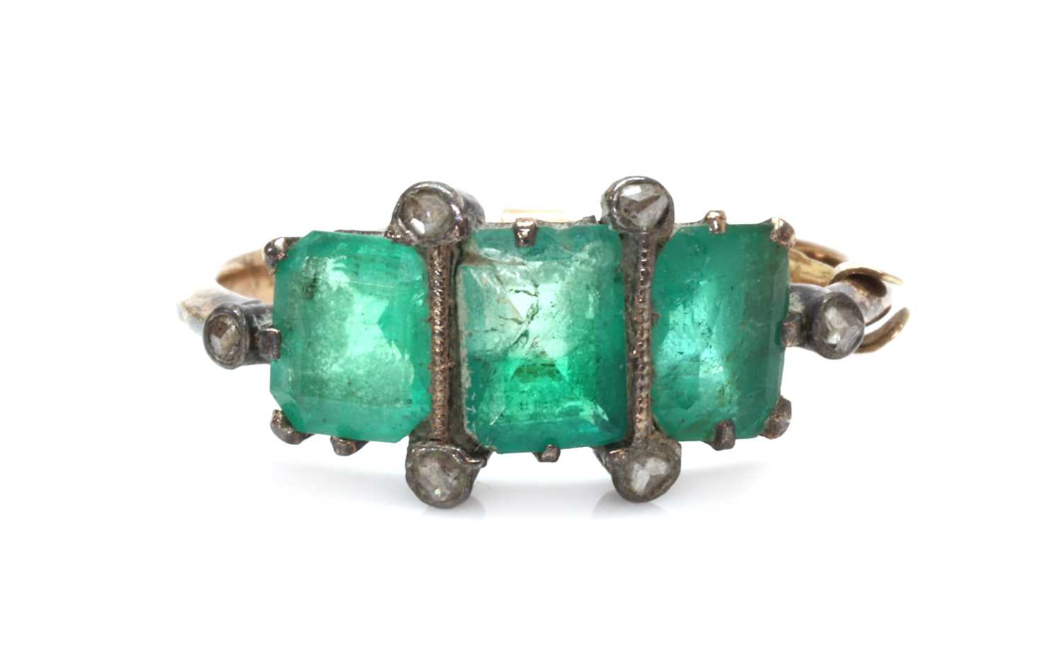 Lot 1016 - A gold and silver, emerald and diamond ring