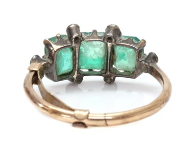Lot 1016 - A gold and silver, emerald and diamond ring