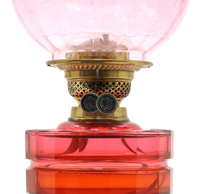 Lot 263 - A Victorian cranberry glass oil lamp