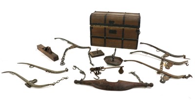Lot 296 - An old trunk containing three pairs of brass and iron horse hames