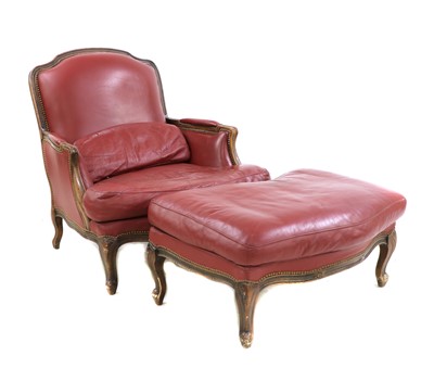 Lot 449 - A large French beech and red leather upholstered armchair and 'run up' stool