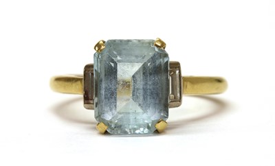 Lot 1274 - A gold blue topaz and diamond three stone ring