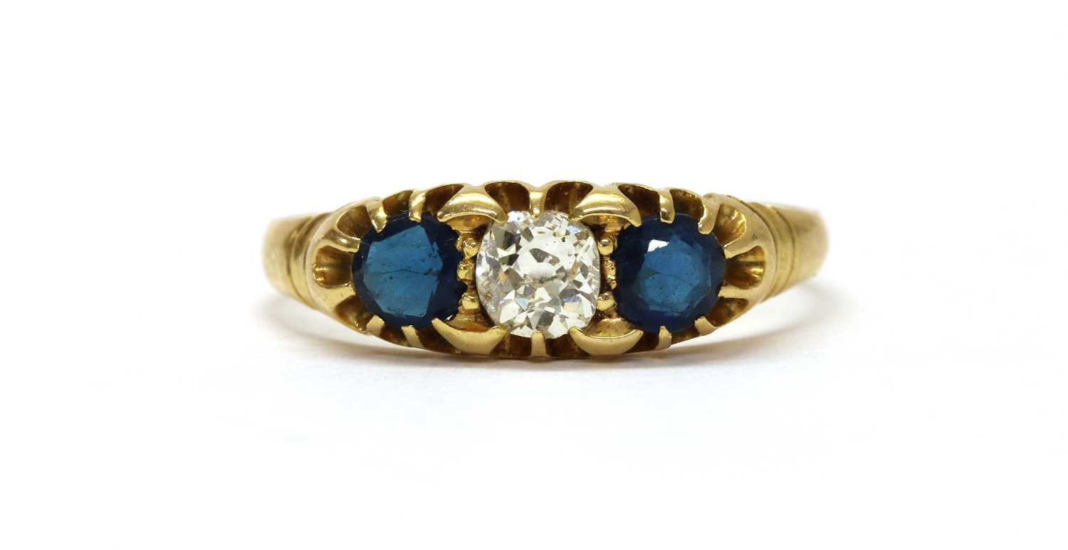 Lot 1027 - An Edwardian gold diamond and sapphire three stone ring