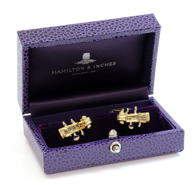 Lot 231 - A pair of 18ct yellow and white gold violin scroll cufflinks, by Deakin and Francis, retailed by Hamilton & Inches