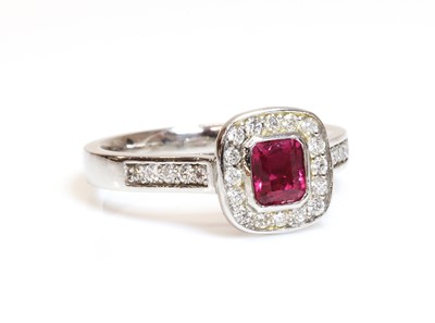 Lot 323 - A platinum, ruby and diamond cushion shaped halo cluster ring