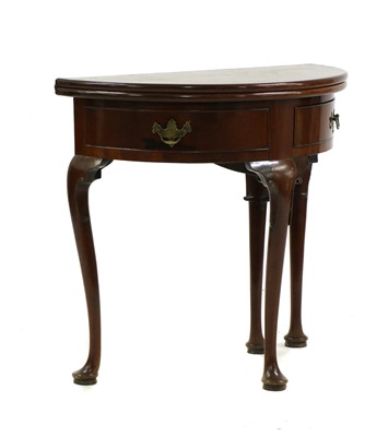 Lot 443 - A George II mahogany demi-lune foldover tea table