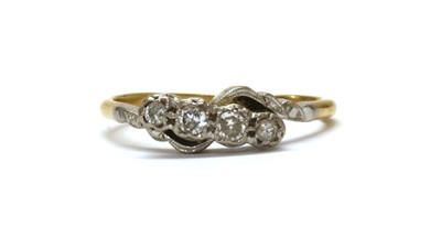 Lot 1174 - A gold four stone diamond ring