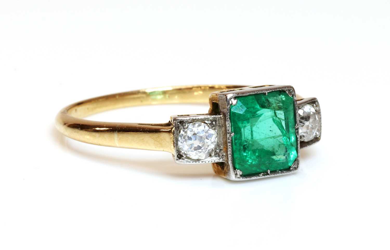 Lot 348 - A three stone emerald and diamond ring