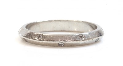 Lot 42 - A platinum chevron section diamond set wedding ring