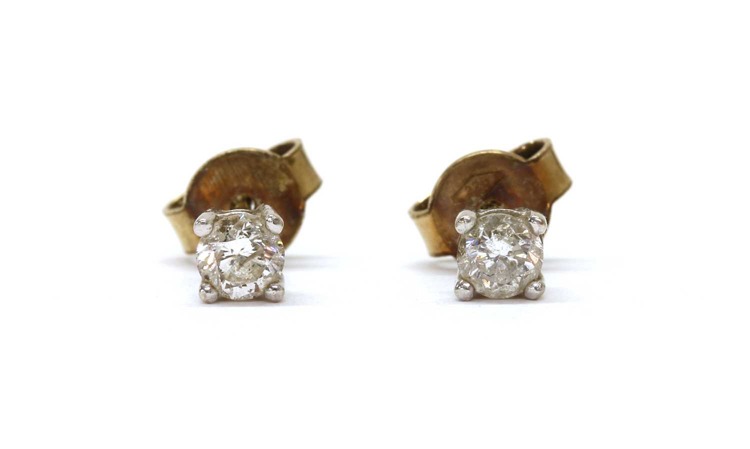 Lot 1171 - A pair of gold single stone diamond stud earrings