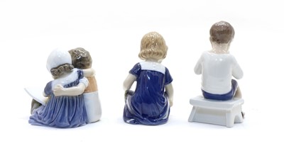 Lot 161 - A Royal Copenhagen figure group of a boy and girl reading