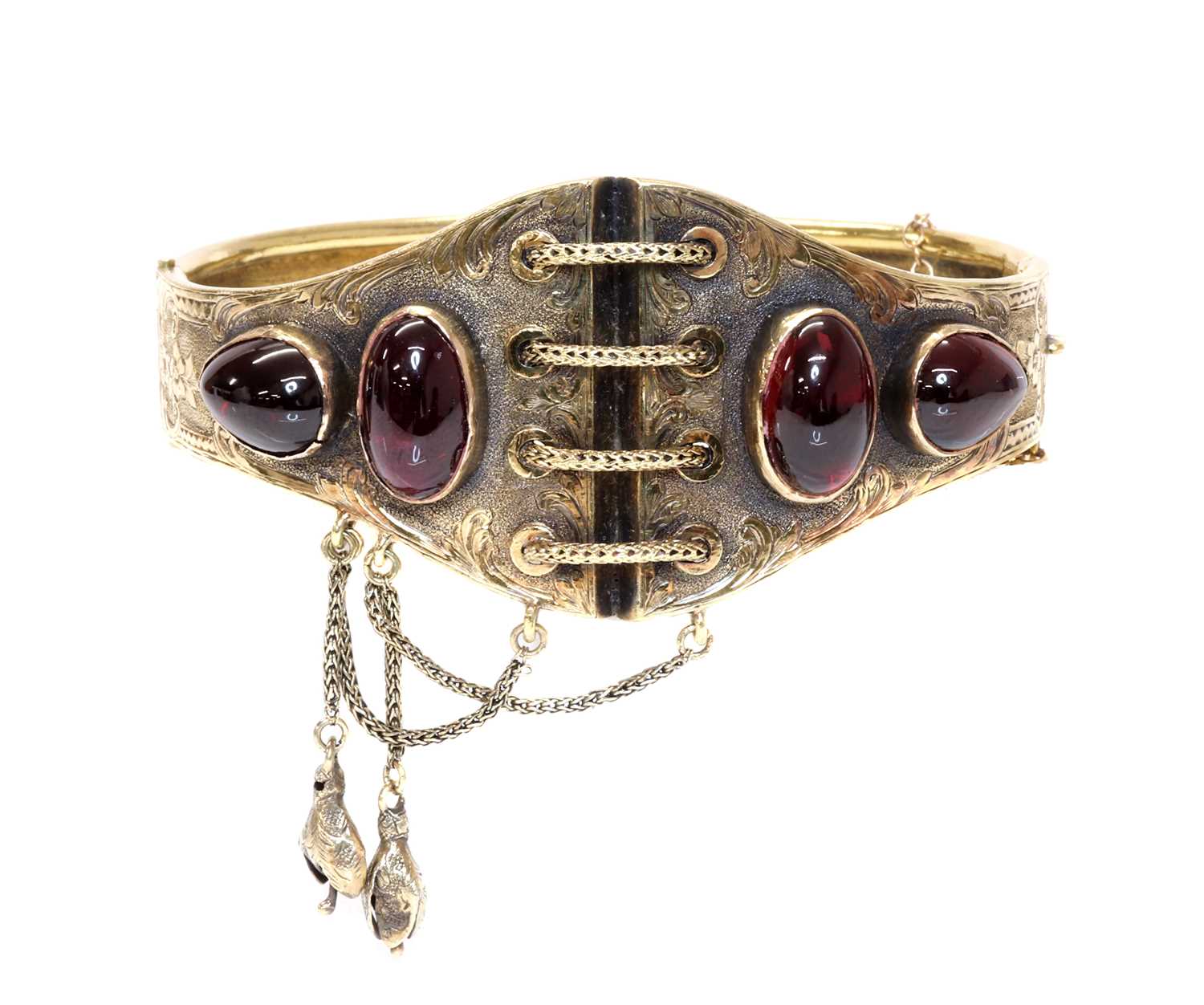 Lot 65 - A Victorian gold garnet set hinged bangle, c.1860