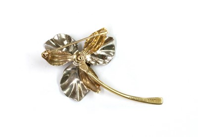 Lot 1056 - A 9ct yellow and white gold flower brooch, by Ecco