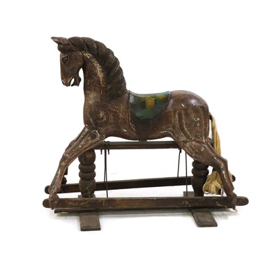 Lot 282 - A carved wooden rocking horse