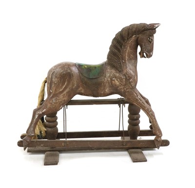 Lot 282 - A carved wooden rocking horse