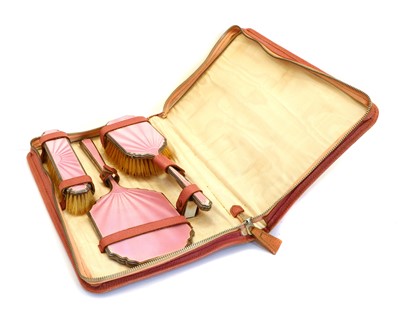 Lot 7 - A silver and pink guilloche enamel cased dressing table set