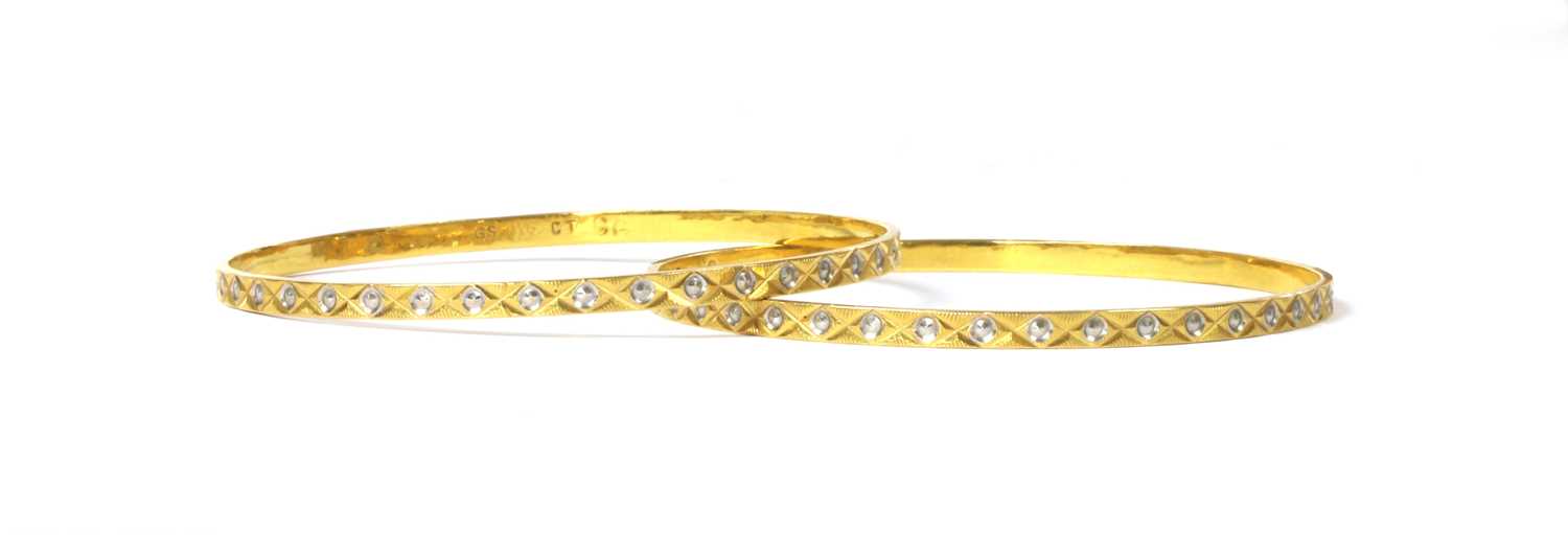 Lot 1158 - A pair of Indian high carat gold bangles