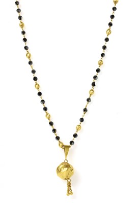 Lot 1151 - An Indian high carat gold pendant and chain