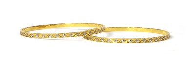 Lot 1159 - A pair of Indian high carat gold bangles