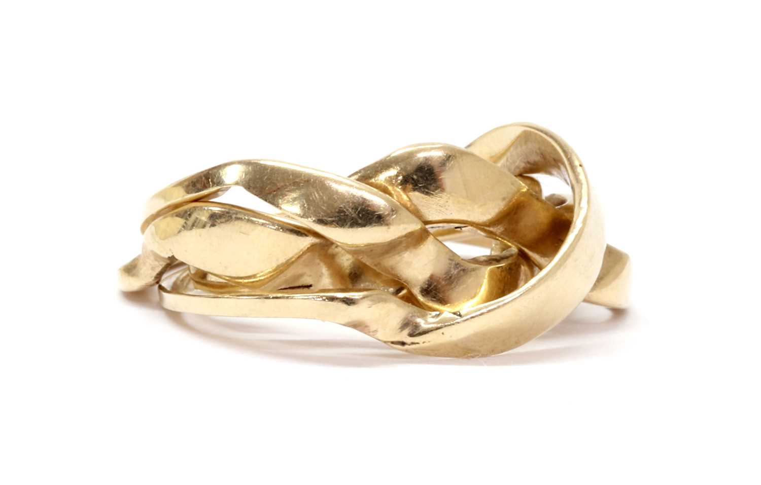 Lot 1083 - A gold four row puzzle ring