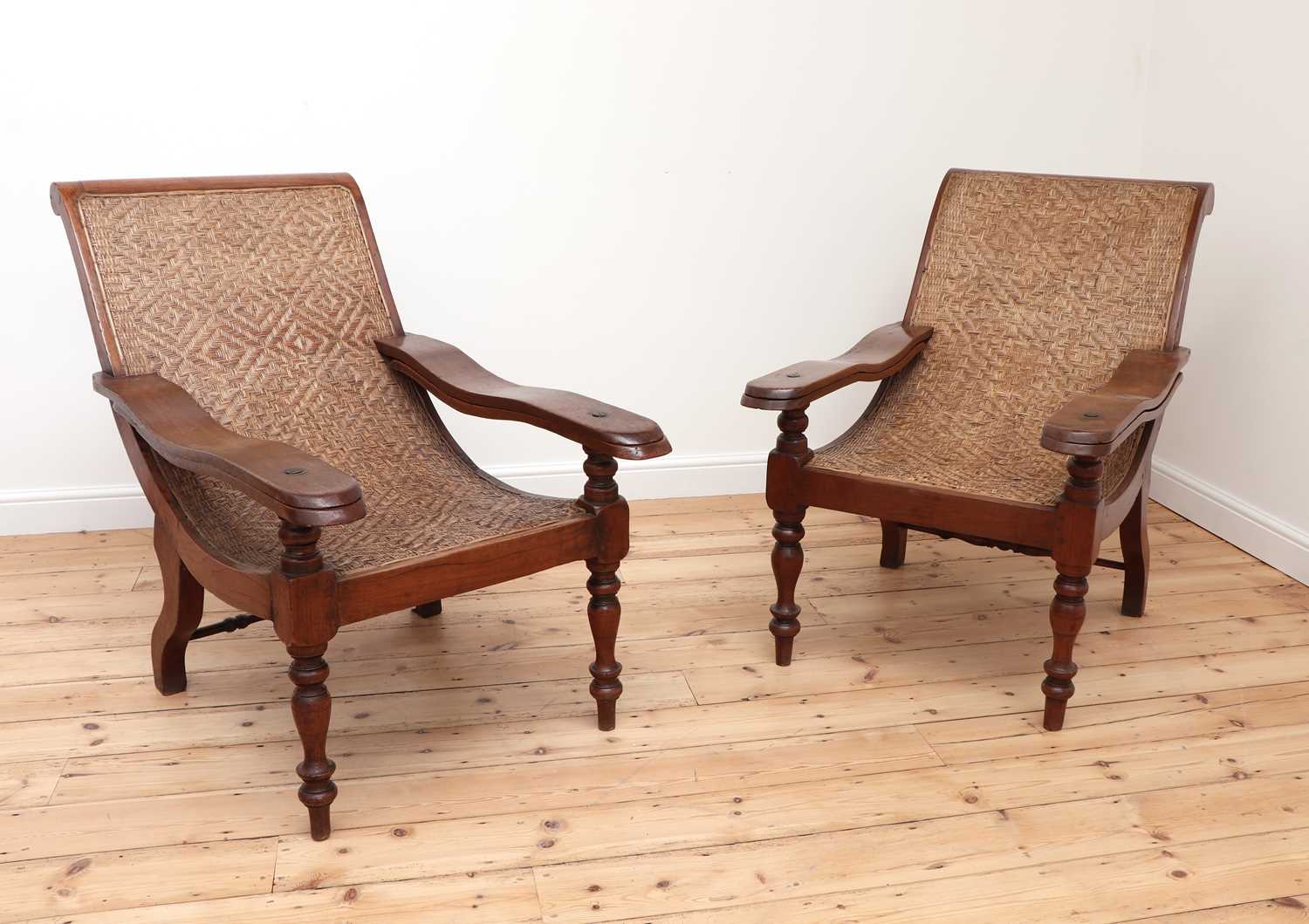 Lot 484 - A pair of Indian teak planter's chairs