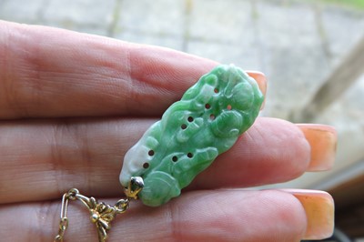 Lot 185 - An American carved jade plaque necklace, c.1925