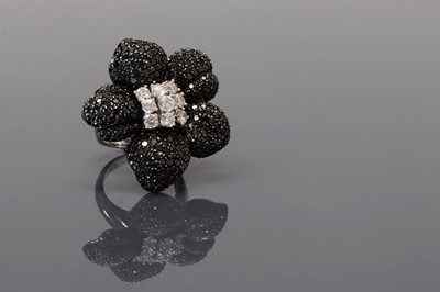 Lot 375 - A Continental white and black diamond orchid ring, c.1990