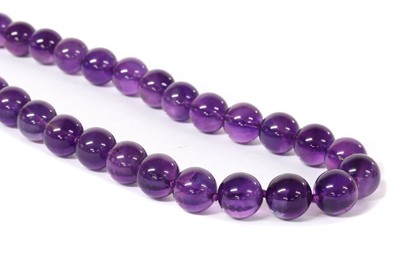 Lot 1256 - A single row uniform amethyst bead necklace
