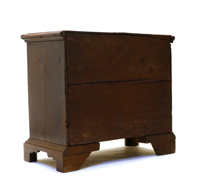 Lot 102 - A small yew wood chest of four drawers