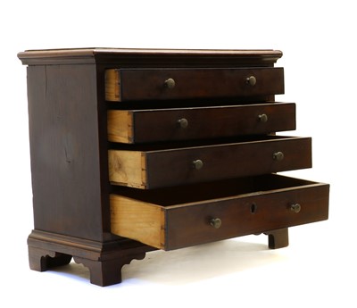 Lot 102 - A small yew wood chest of four drawers