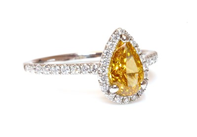 Lot 453 - A platinum fancy orange-yellow diamond and diamond halo cluster ring