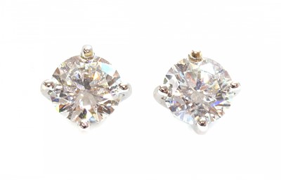 Lot 438 - A pair of white gold single stone diamond earrings