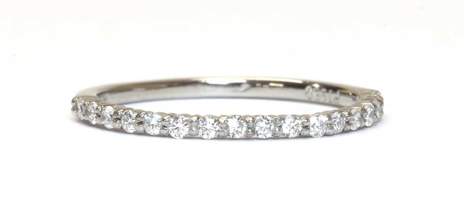 Lot 1207 - A platinum diamond half eternity ring