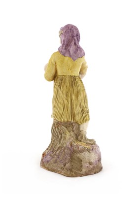 Lot 286 - A pottery figure of a girl holding a baby