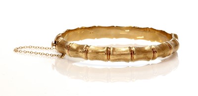 Lot 253 - A 9ct gold hollow hinged bangle, by Henry Griffith and Sons