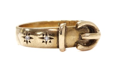 Lot 1184 - A 9ct gold diamond set buckle ring