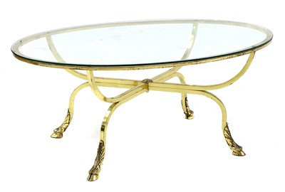 Lot 728 - An oval brass and glass coffee table