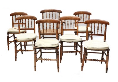 Lot 394 - A set of seven rush seated oak and walnut dining chairs