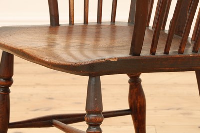 Lot 415 - A George III fruitwood and elm high comb back Windsor chair