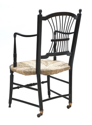 Lot 50 - An ebonised 'Sussex' armchair