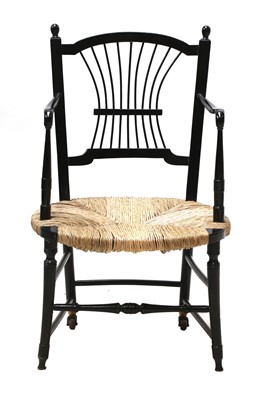 Lot 50 - An ebonised 'Sussex' armchair