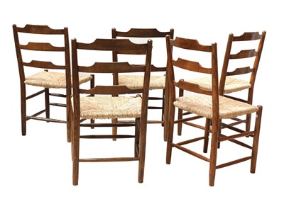 Lot 150 - Five Cotswold School 'Clissett'-style oak ladderback chairs