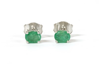 Lot 1269 - A pair of white gold single stone emerald stud earrings