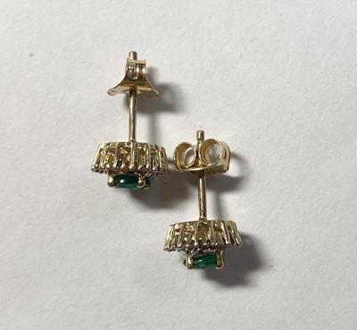 Lot 1266 - A pair of gold emerald and diamond cluster stud earrings