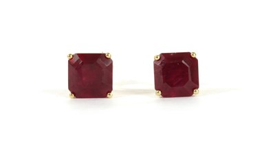 Lot 128 - A pair of gold single stone fracture filled ruby stud earrings