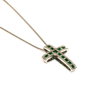 Lot 342 - An 18ct white gold emerald and diamond Latin style cross