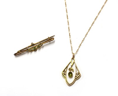 Lot 1357 - An Edwardian gold peridot and split pearl pendant